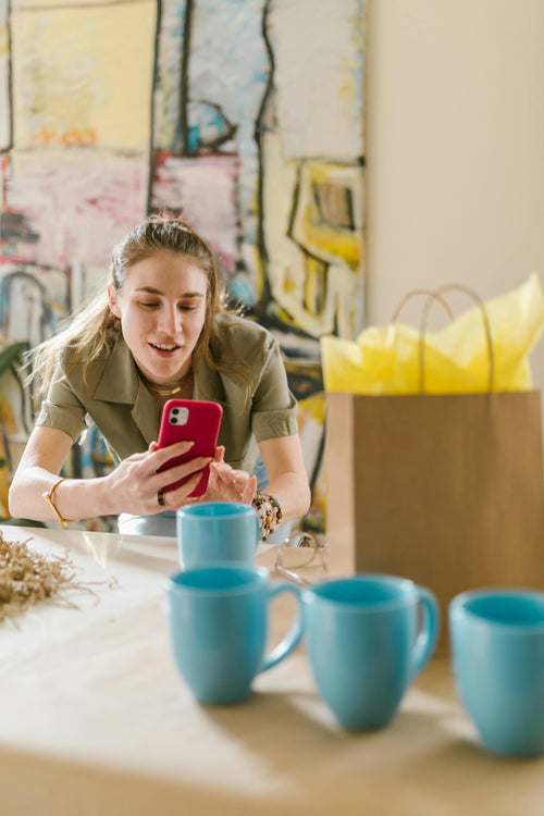 Person doing side hustle on their phone in cozy setting.