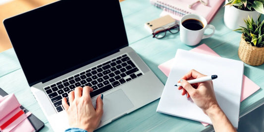 The Dropshipping Side Hustle. A workspace with a laptop and coffee cup.