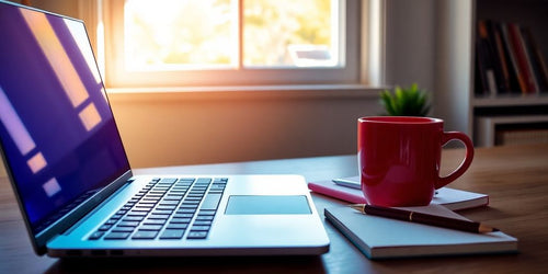 A cozy workspace with a laptop and coffee.